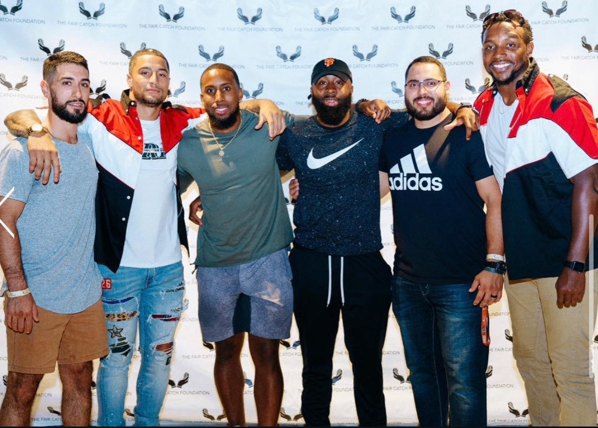 Six guests pose together on the red carpet at the 2018 Bowl with the Pros Charity Event.
