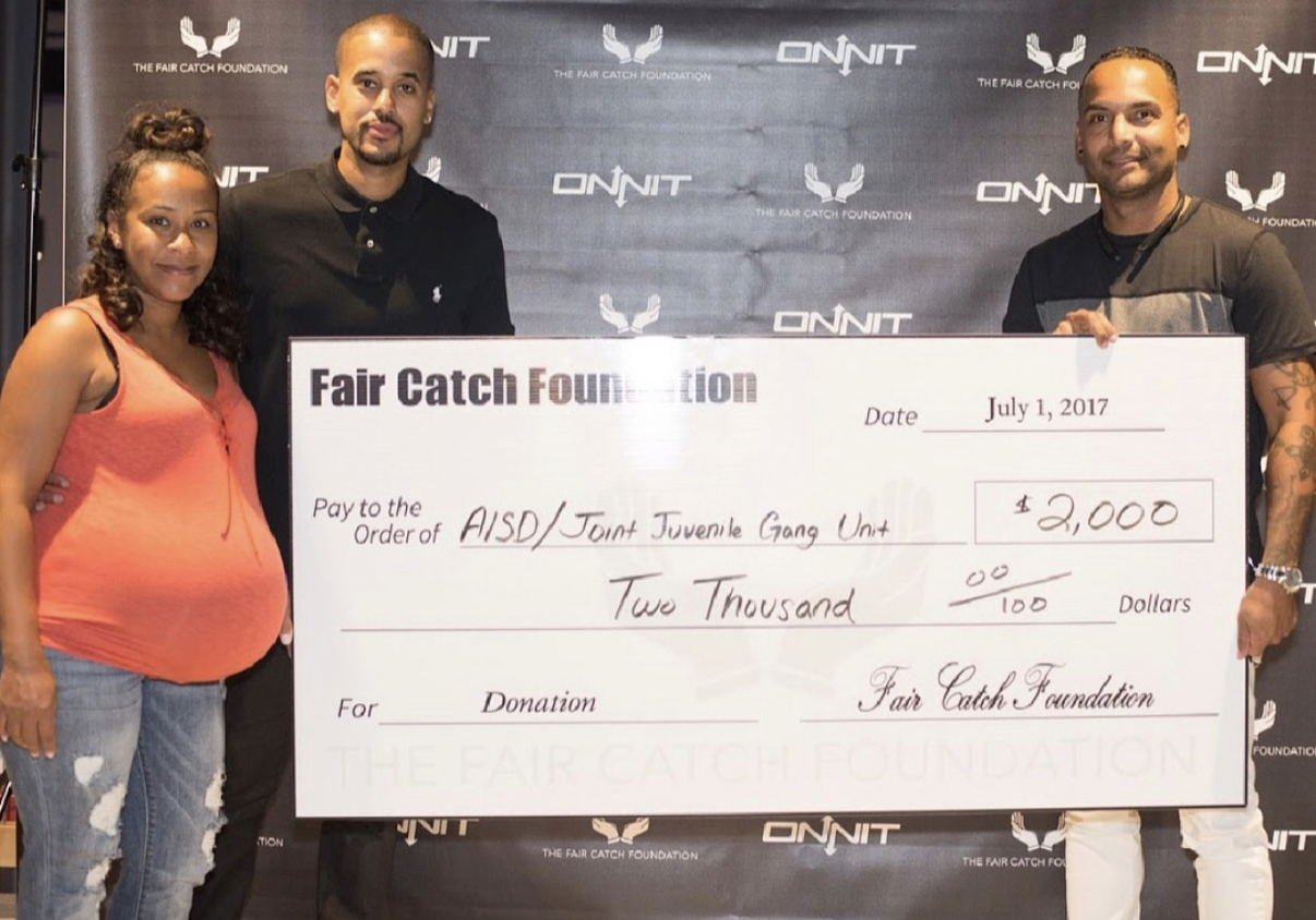 The Fair Catch Foundation presenting a $2,000 grant to AISD Joint Juvenile Gang Unit.