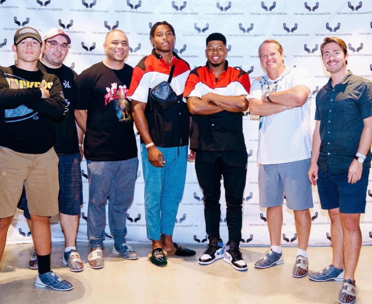 Eight celebrity guests pose together on the red carpet at the 2018 Bowl with the Pros Charity Event.