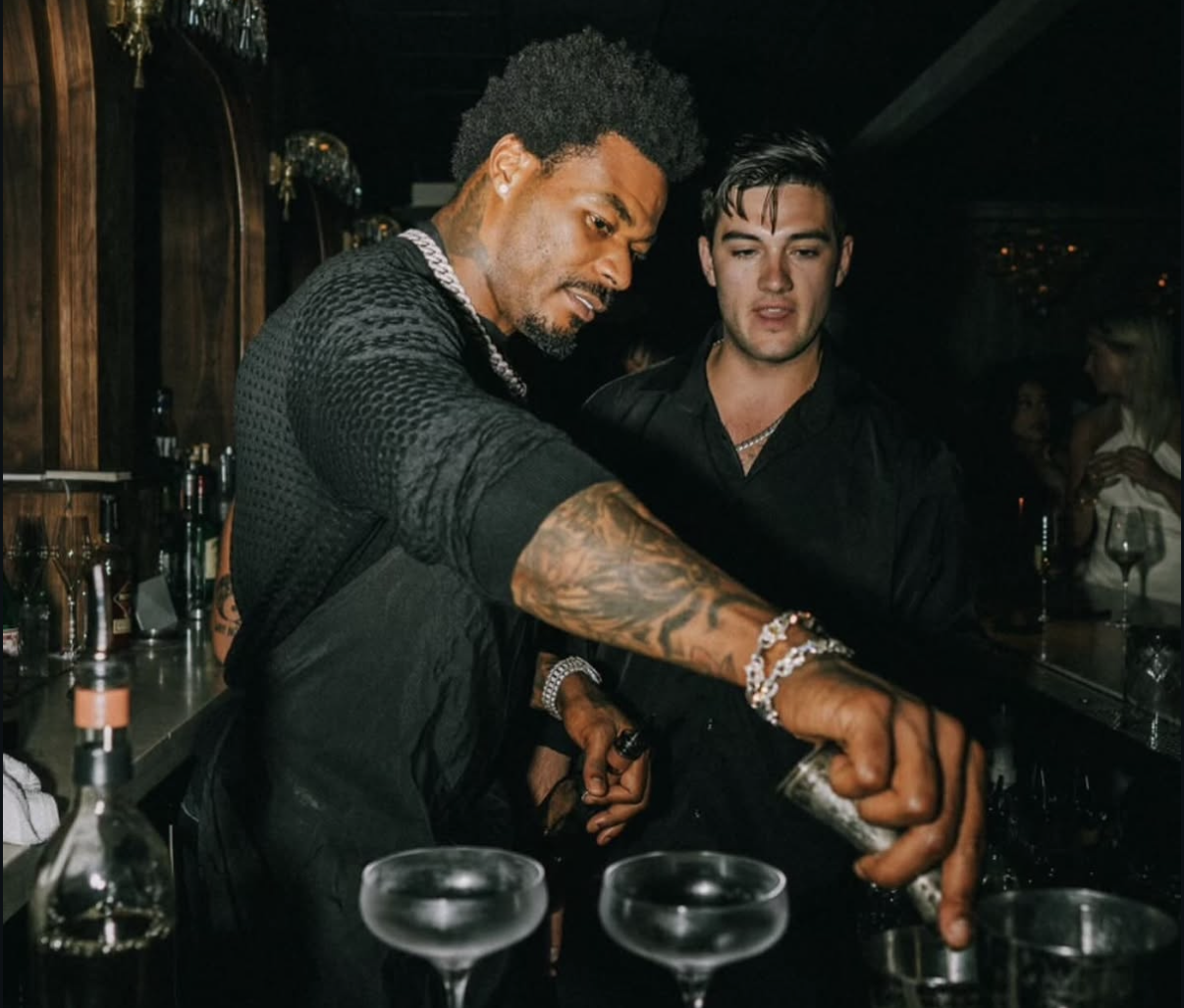 Two waiters mix cocktails behind the bar during the 2024 event.