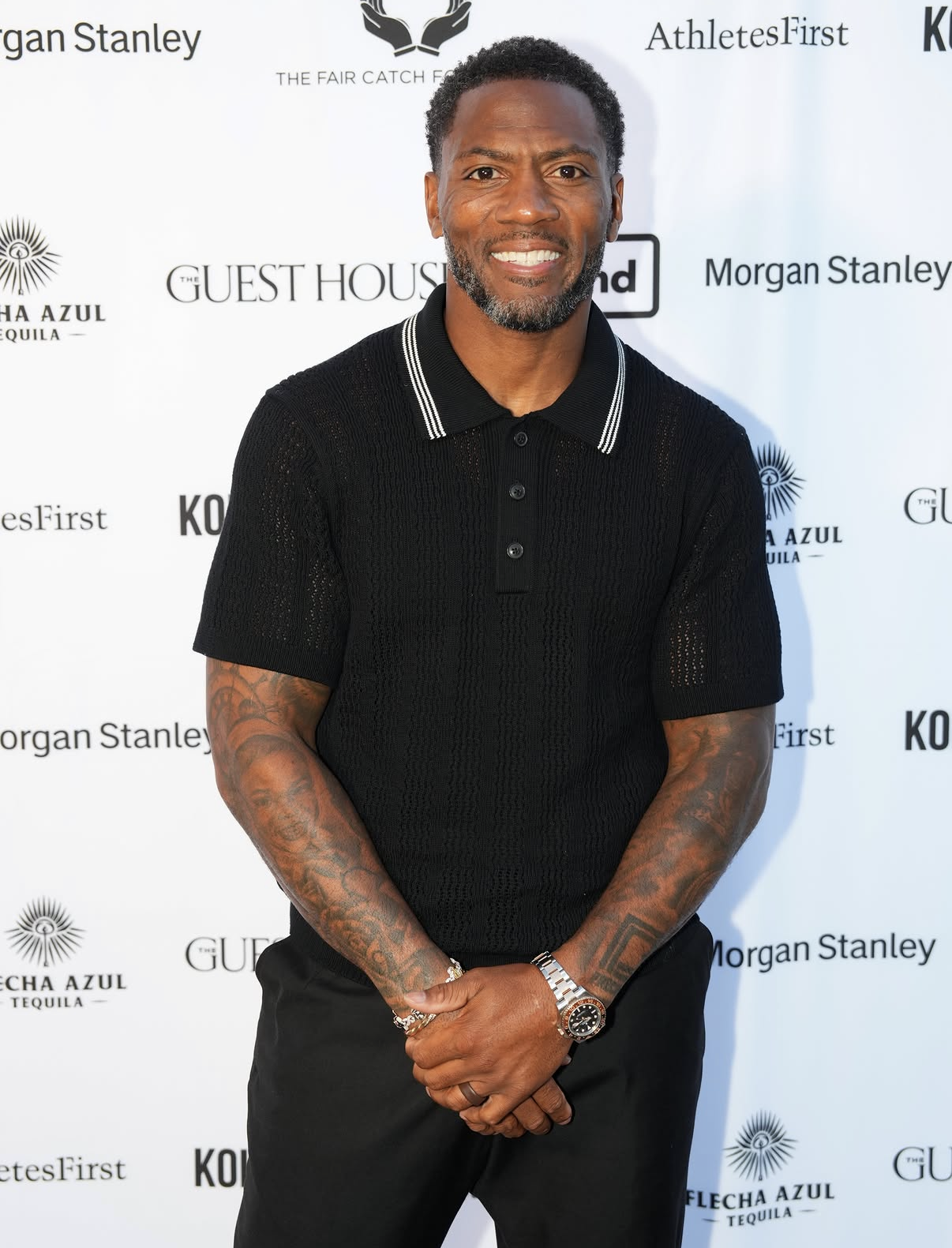 A guest smiles on the sponsor step-and-repeat at the 2026 Celebrity Waiter Night.