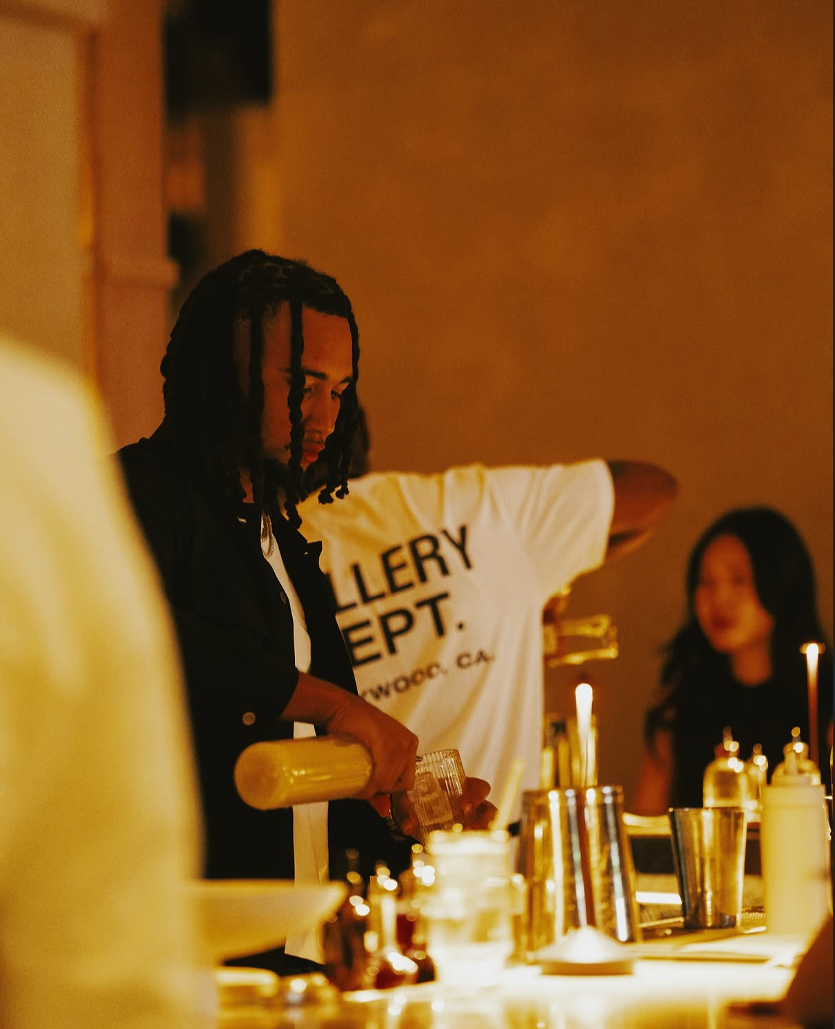 A celebrity bartender crafts cocktails behind the bar during the 2025 event.