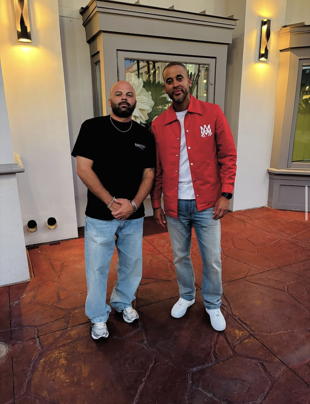 Two guests pose outside the venue entrance before the 2025 Celebrity Waiter Night begins.