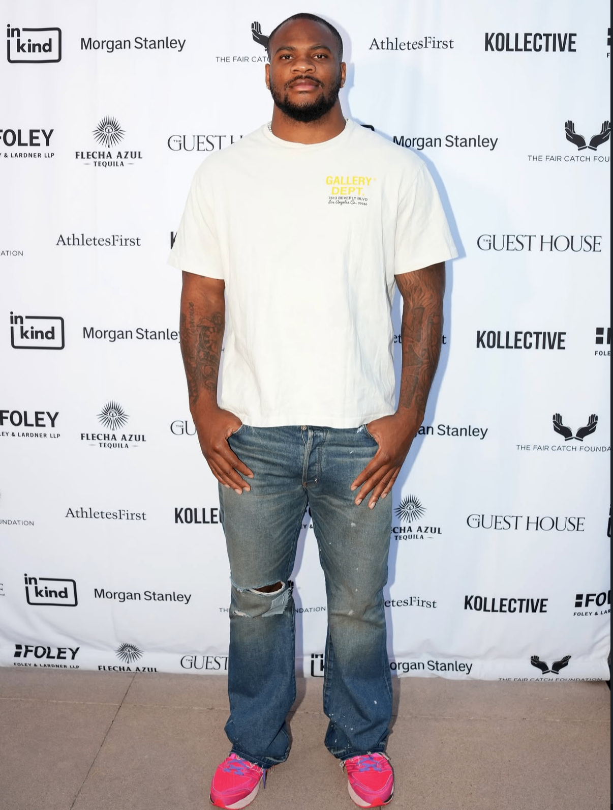 A guest poses on the red carpet in a Gallery Dept tee and jeans at the 2025 Celebrity Waiter Night.