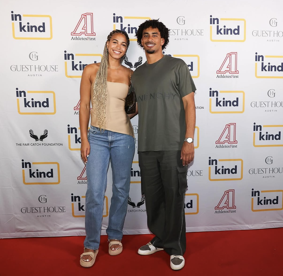 Two guests pose together on the 2024 Austin step-and-repeat.