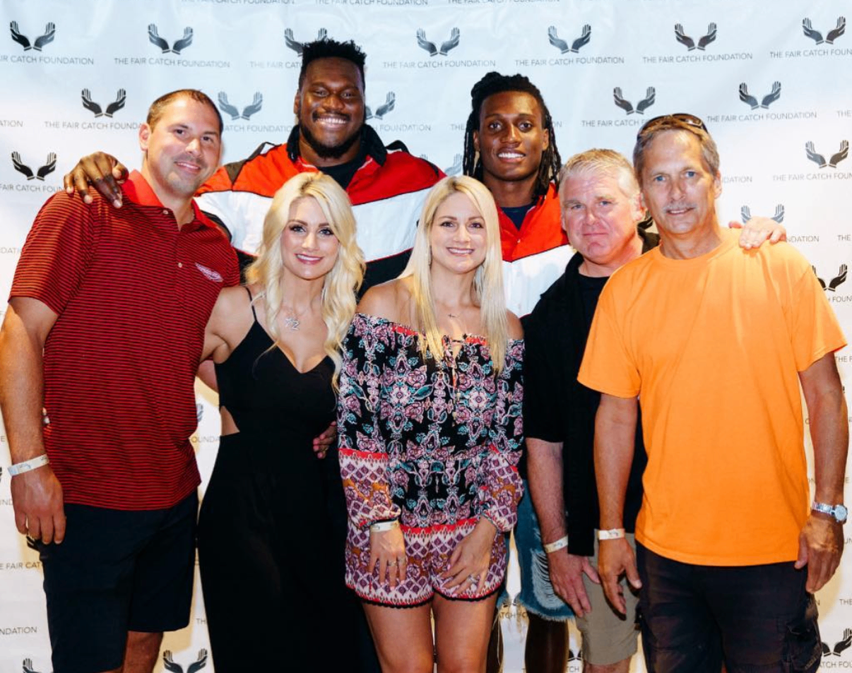Two celebrity guests pose with fans and supporters on the step-and-repeat at the 2018 Bowl with the Pros Charity Event.