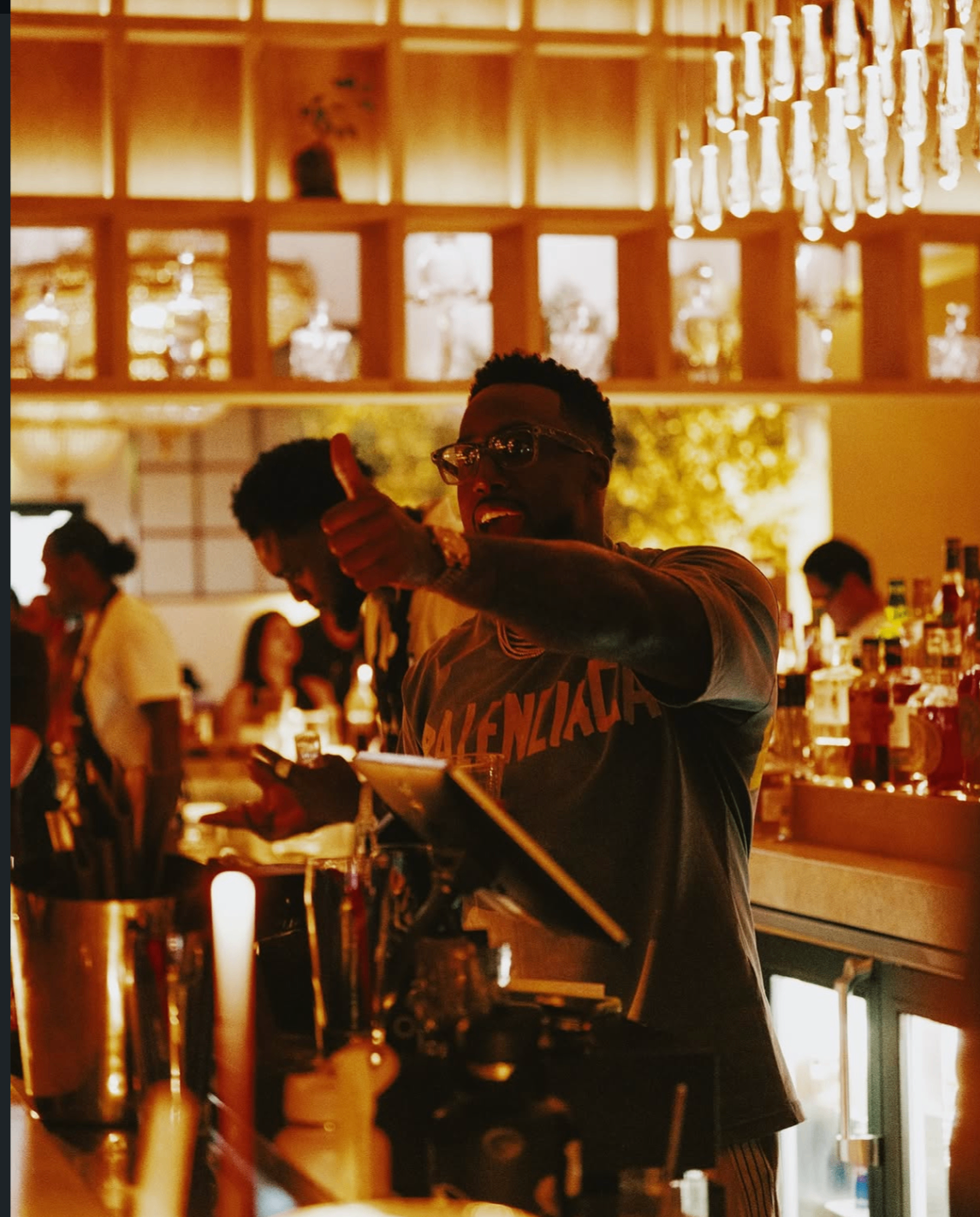 A thumbs-up from behind the bar during the 2025 Celebrity Waiter Night.