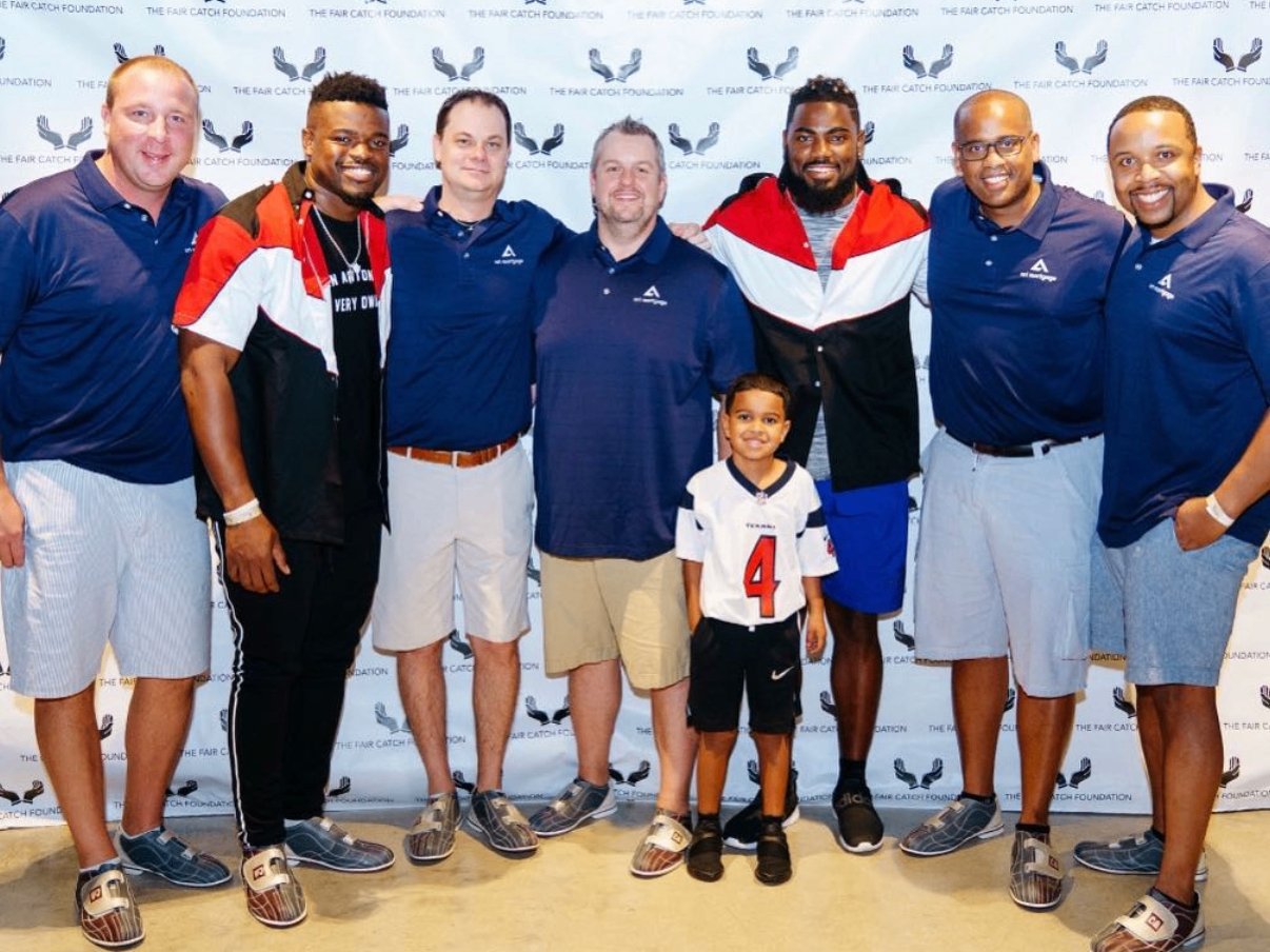 AT&T Mortgage team members pose with celebrity players and a young fan at the 2018 Bowl with the Pros Charity Event.