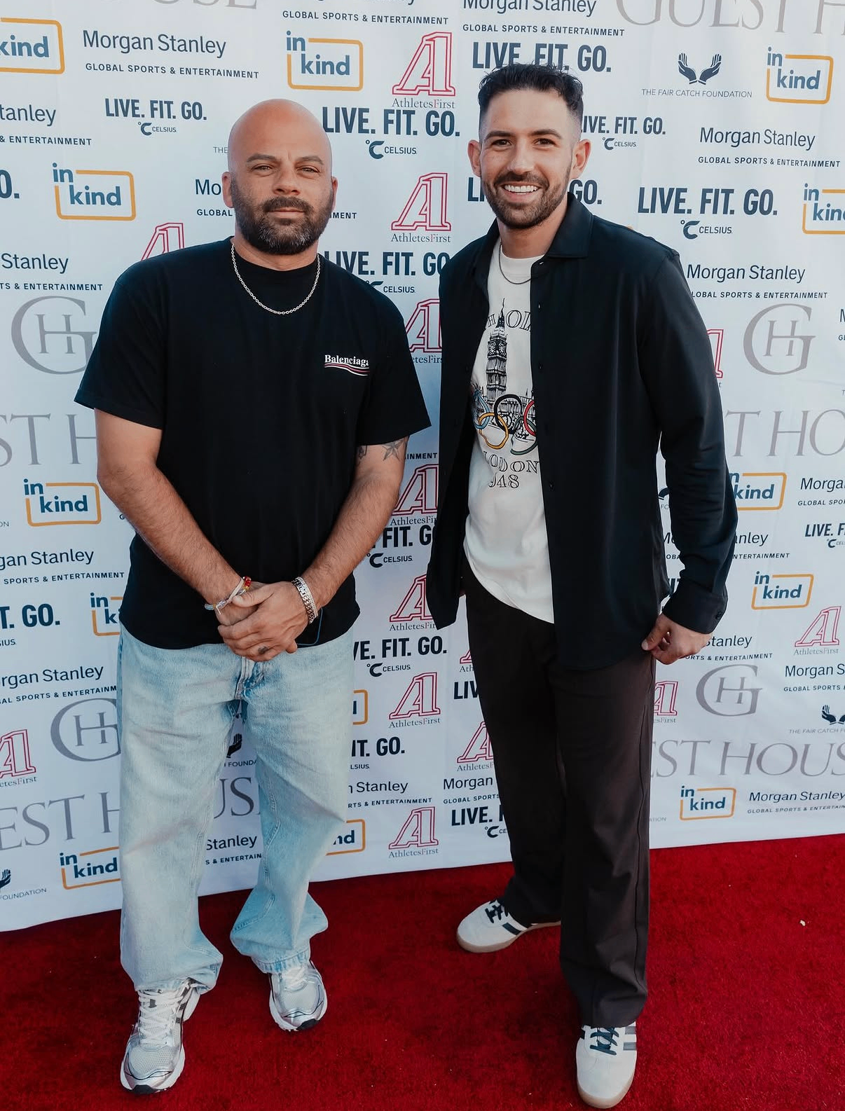 Two guests pose on the red carpet in front of the sponsor step-and-repeat at the 2025 event.
