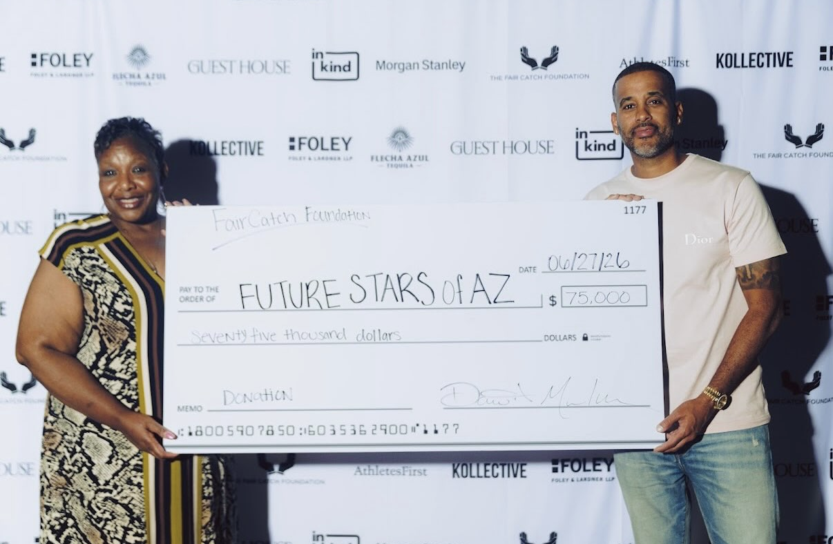 David Mulugheta presents a $75,000 donation check to Future Stars of AZ at the 2026 Celebrity Waiter Night.