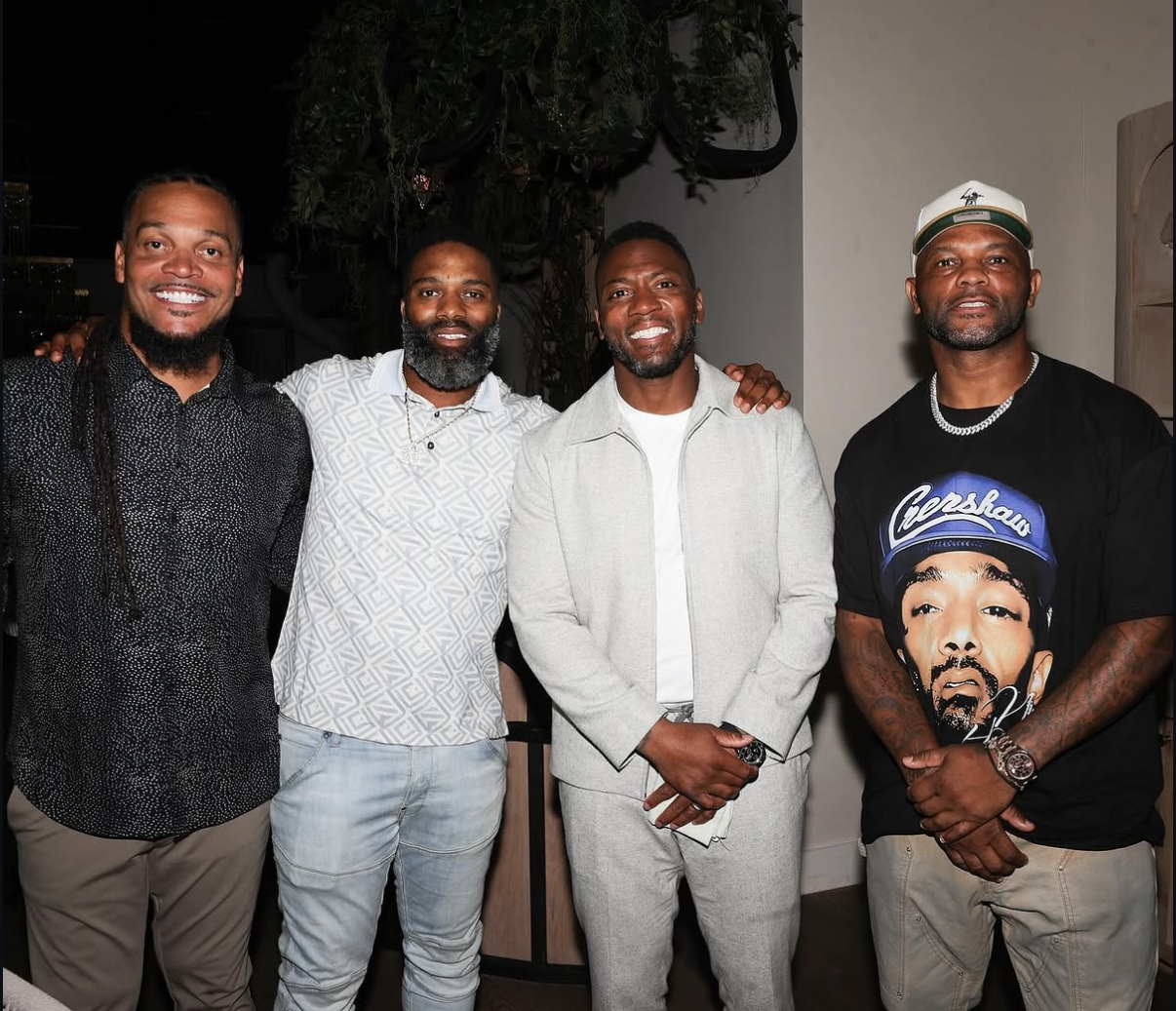 Four men pose together inside the venue during Celebrity Waiter Night 2024.