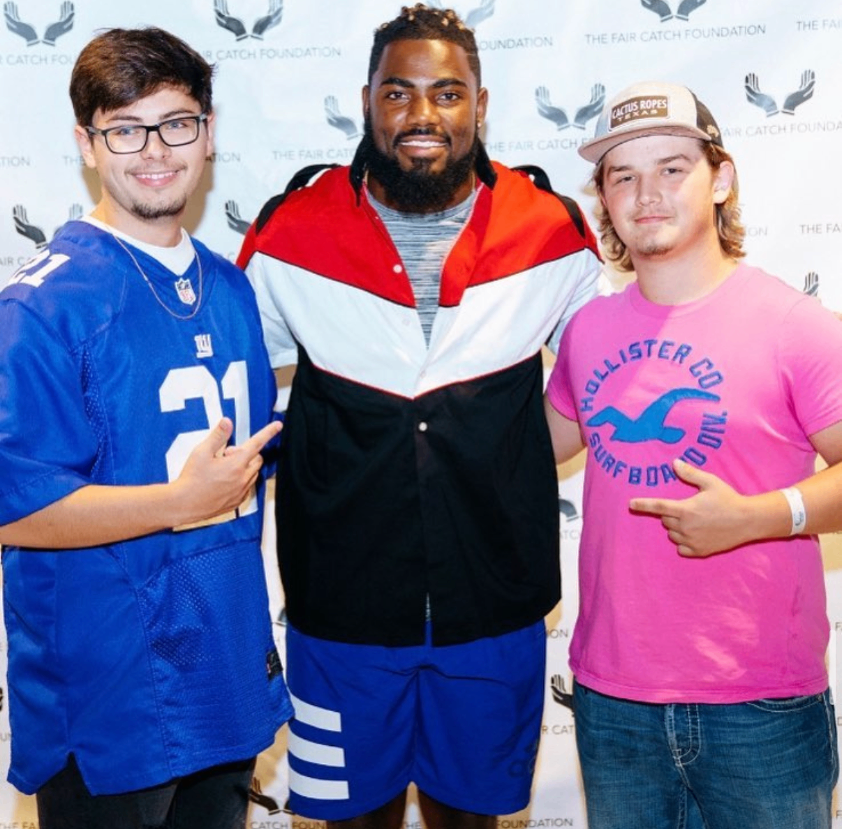 Two young fans pose with an NFL player at the 2018 Bowl with the Pros Charity Event.