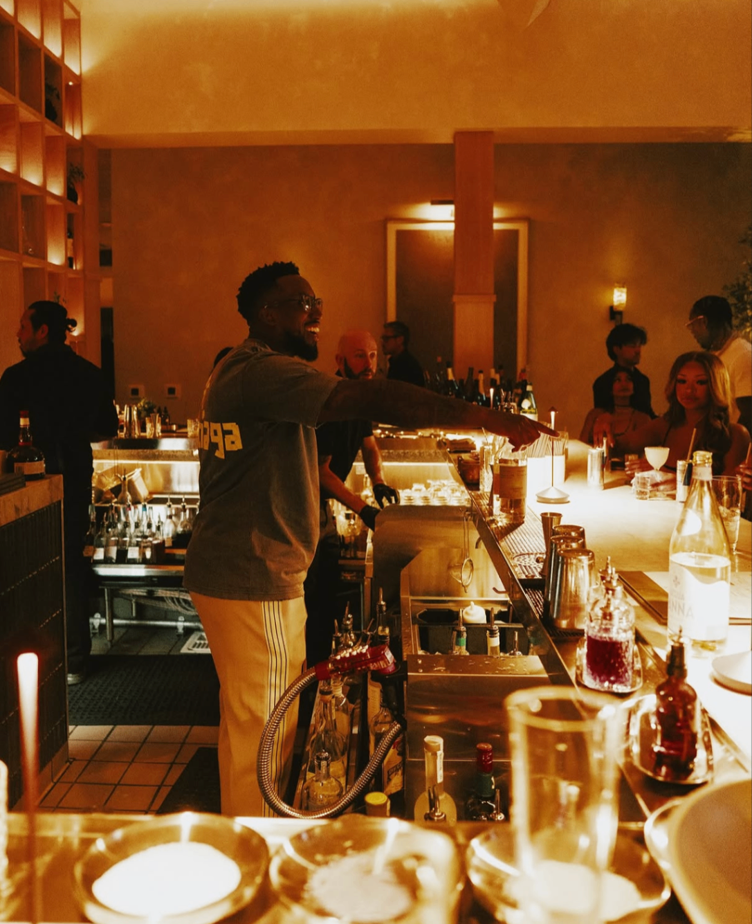 Guests gathered around the glowing bar during the 2025 Celebrity Waiter Night.