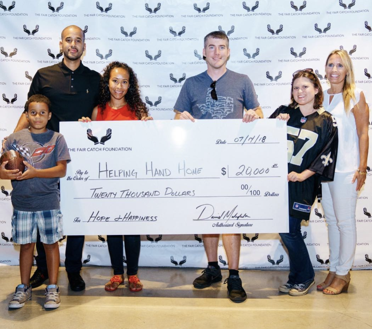 The Fair Catch Foundation presenting a $20,000 grant to Helping Hand Home.