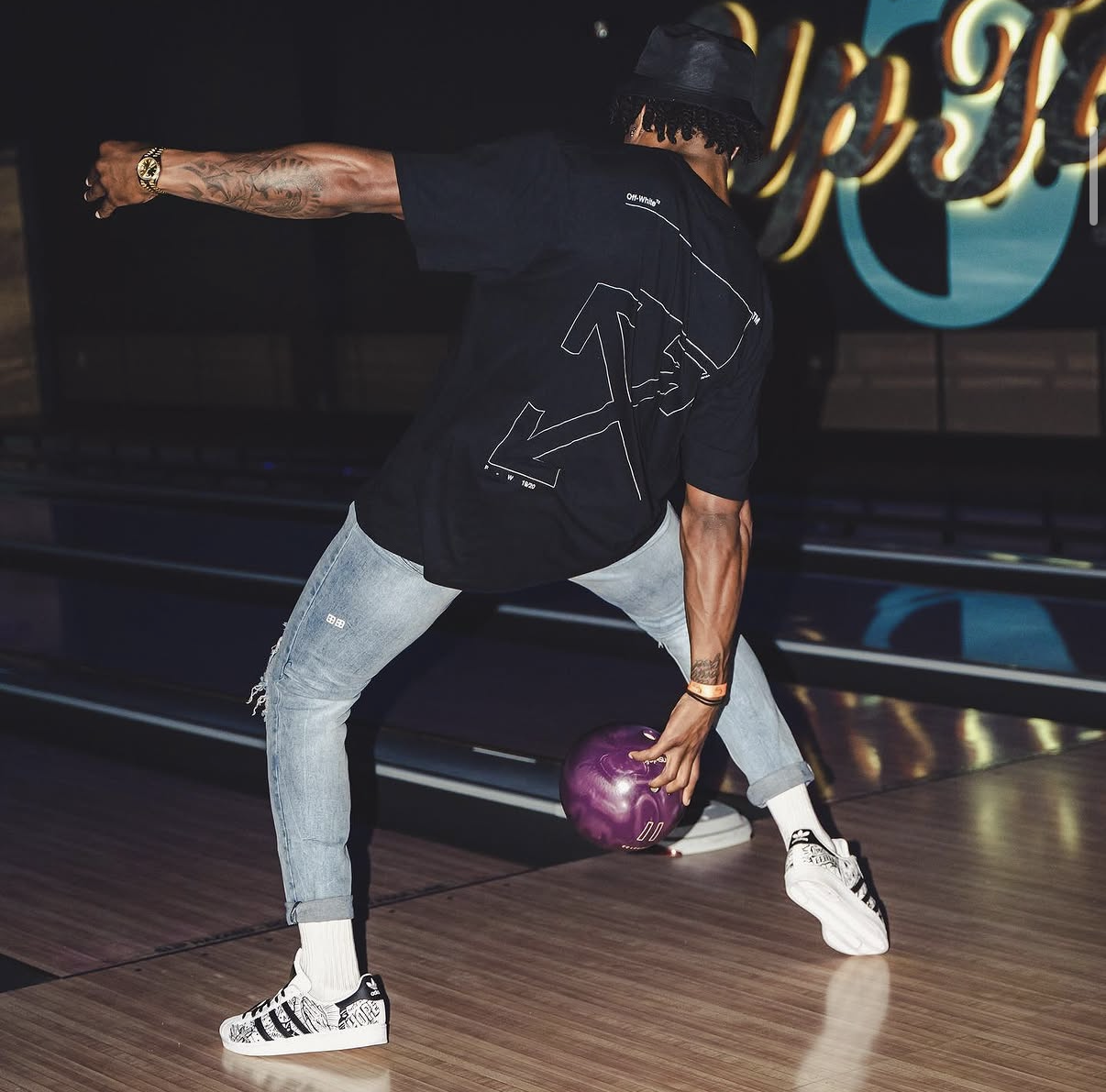 An NFL player in an Off-White tee winds up his release at the 2019 Bowl with the Pros Charity Event.