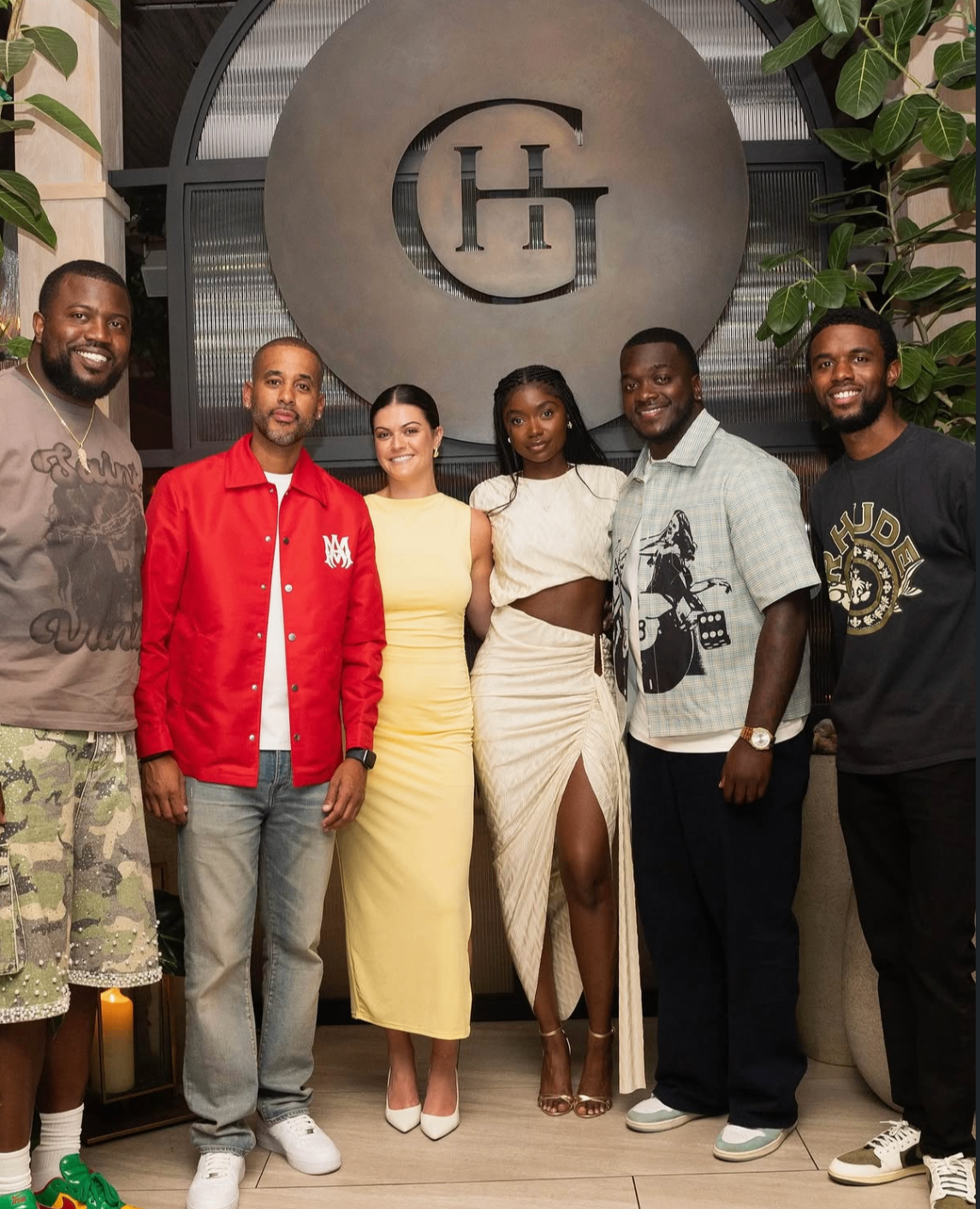 Group photo of the 2025 Celebrity Waiter Night hosts in front of the Guest House signage.